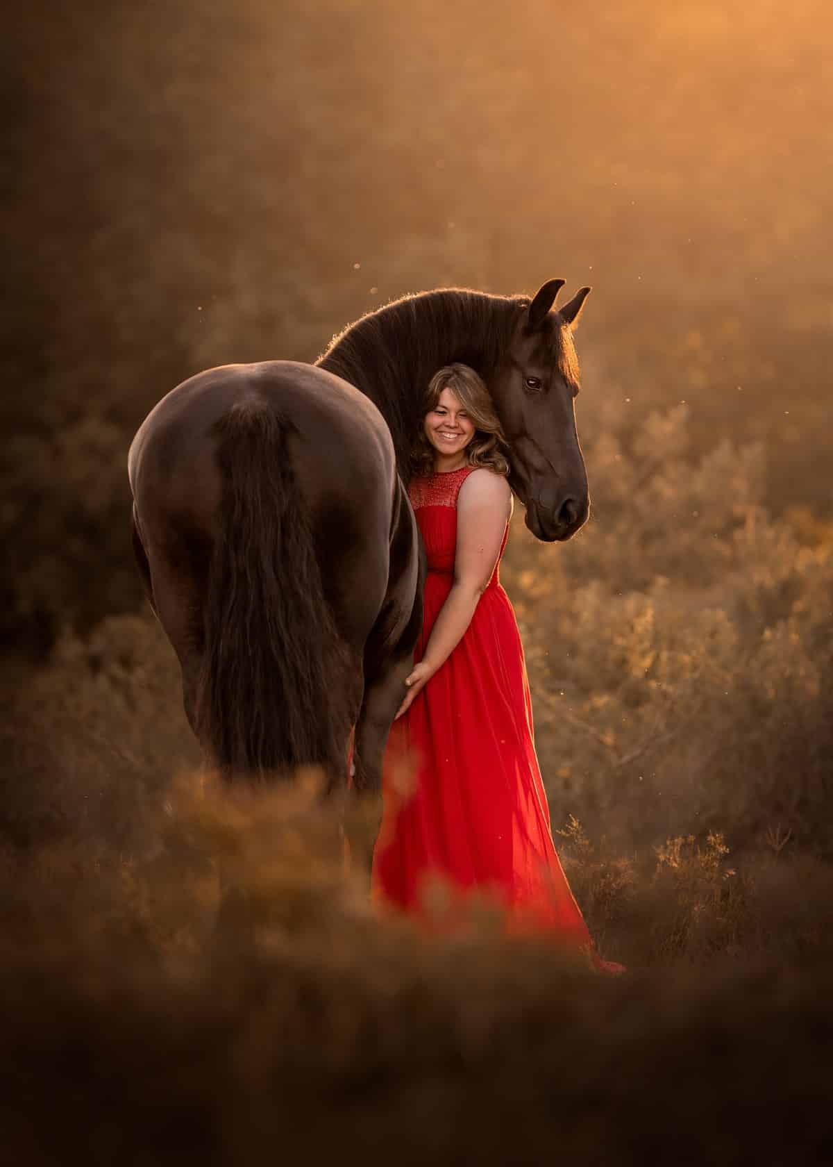 Woman in a red dress with her horse