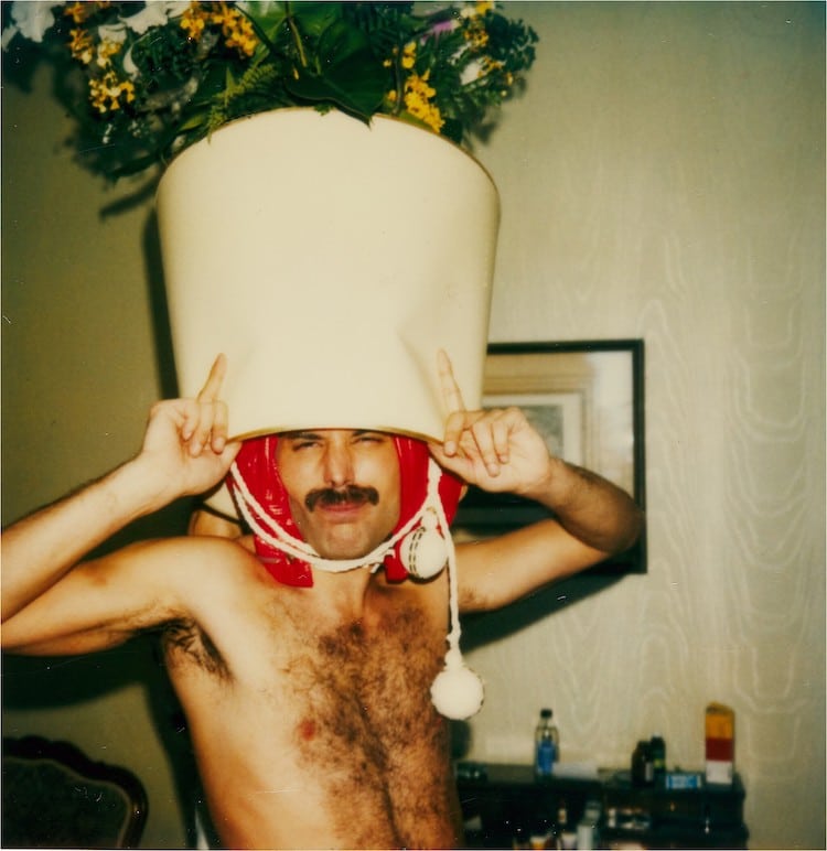 A shirtless Freddie Mercury wearing a funny hat