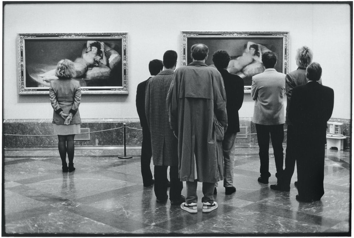 People standing in front of a painting at the Prado Museum by Elliott Erwitt
