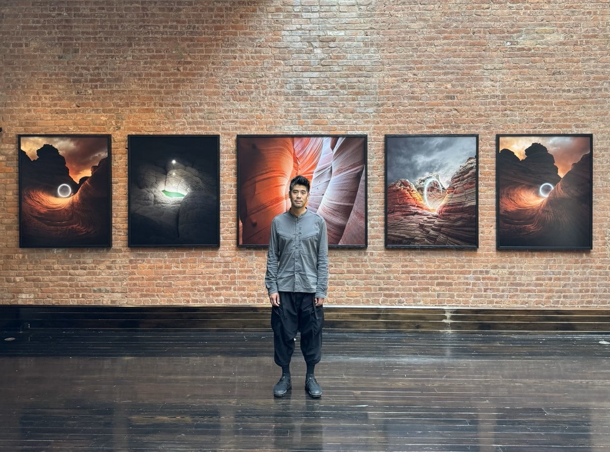 Reuben Wu Standing in Front of His Photos for Apple