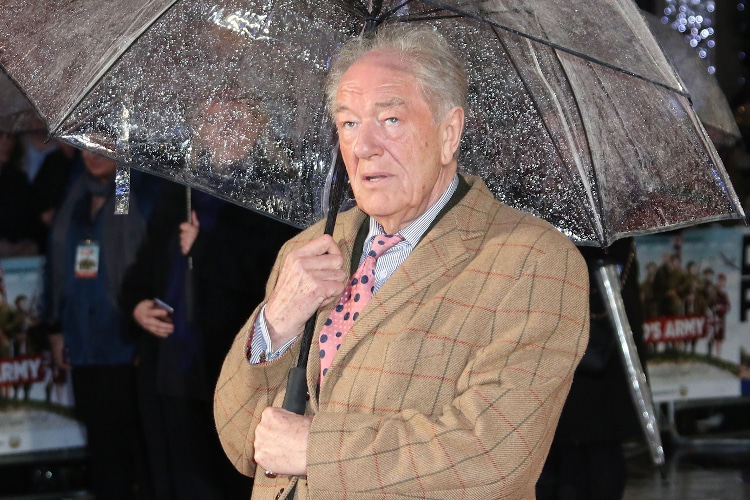 Actor Michael Gambon attends the Dad's Army premiere in London holding an umbrella on January 26, 2016.