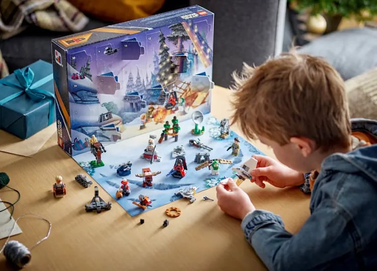 kid playing with toys from lego advent calendar