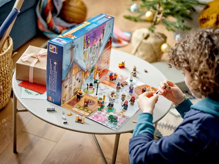 kid playing with toys from lego advent calendar