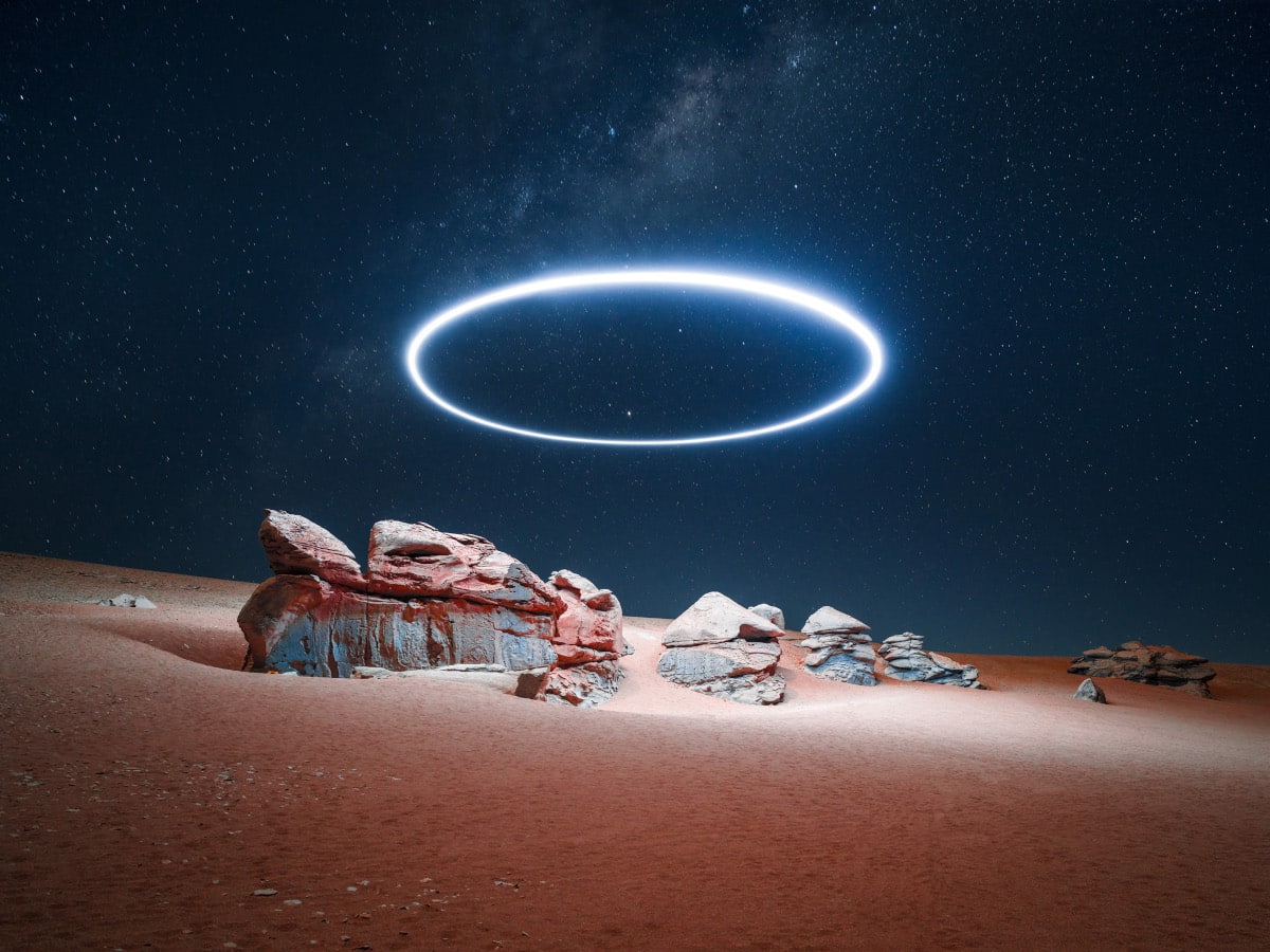 Halo of light over night desert landscape