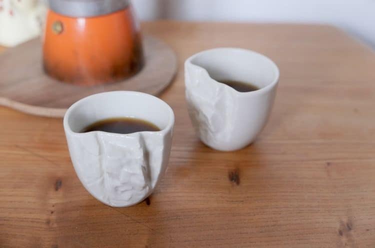 Two Pinch Hold Espresso Mugs with Coffee on Table
