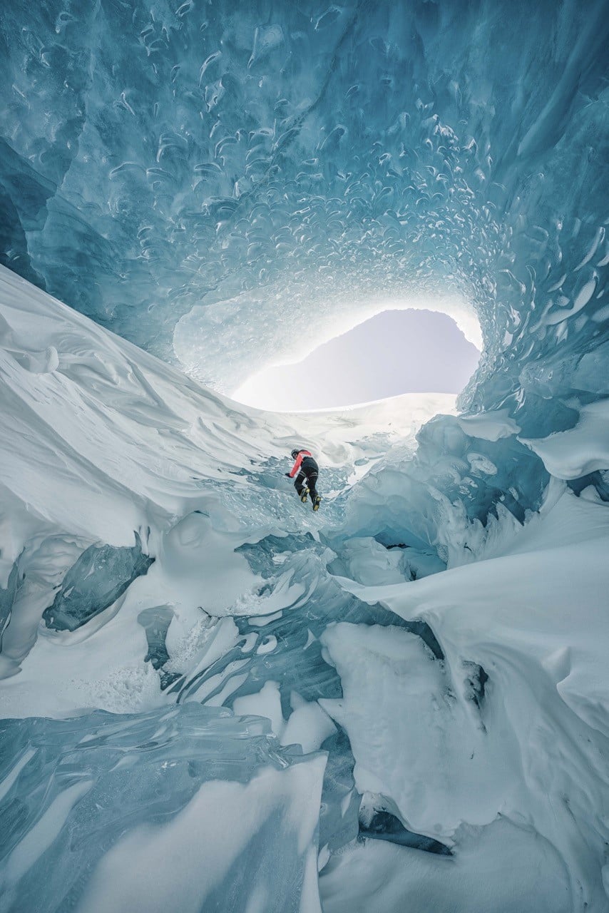 An ice climber scales the inside of a glacier cave on the Icefields Parkway in Banff National Park, Alberta.