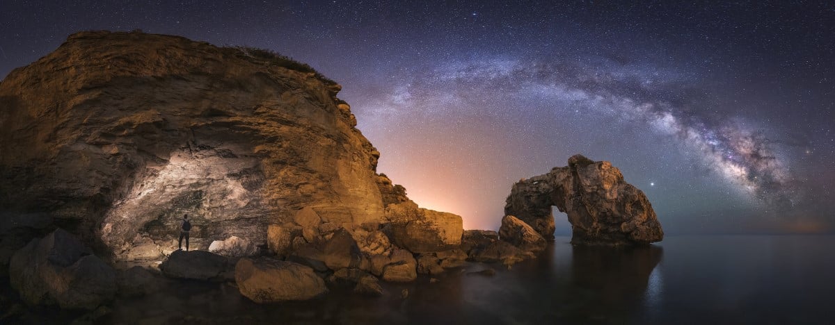 Panoramic night photograph in which I could capture the arch of the Milky Way passing behind the natural arch called Es Pontàs