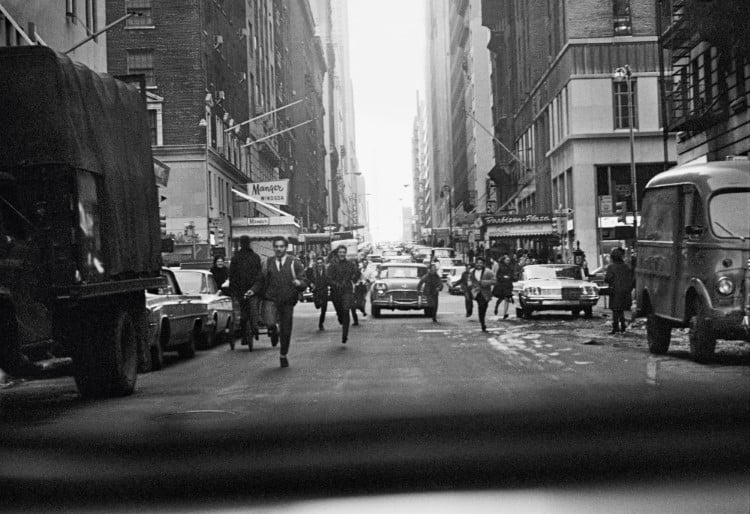 Beatles running acress 6th Avenue in New York in 1964