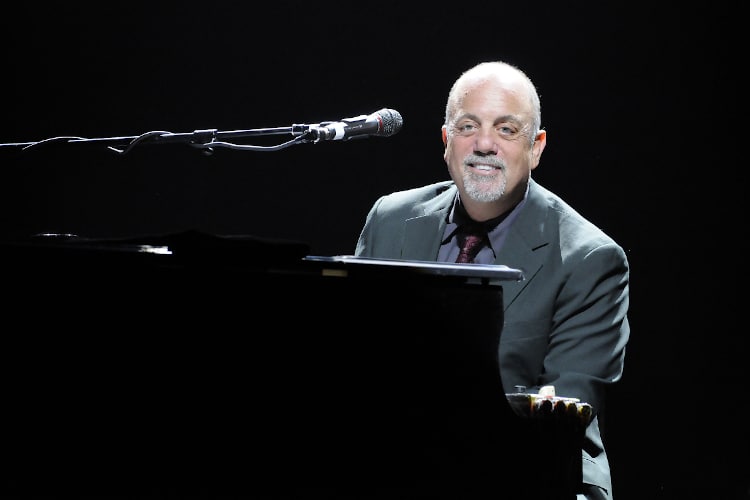 A portrait shot of Singer, songwriter, pianist, legend Billy Joel performing live at the Honda Center in Anaheim, California with black background