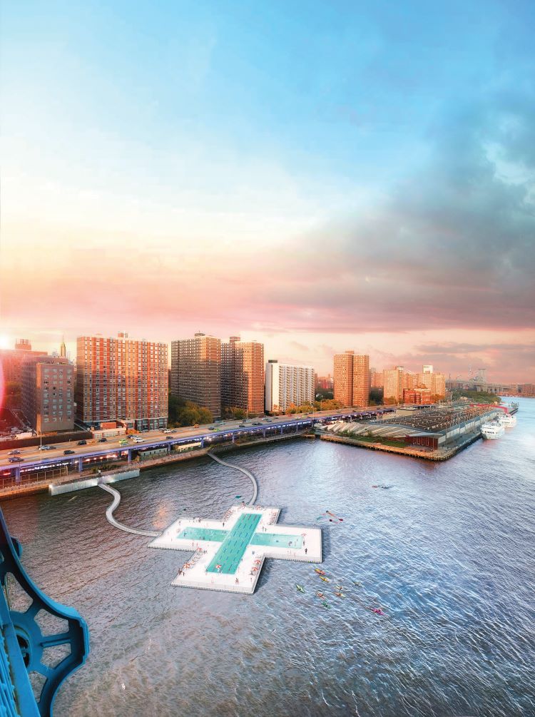 People relaxing on a grassy lawn with a floating pool and the New York City skyline behind them