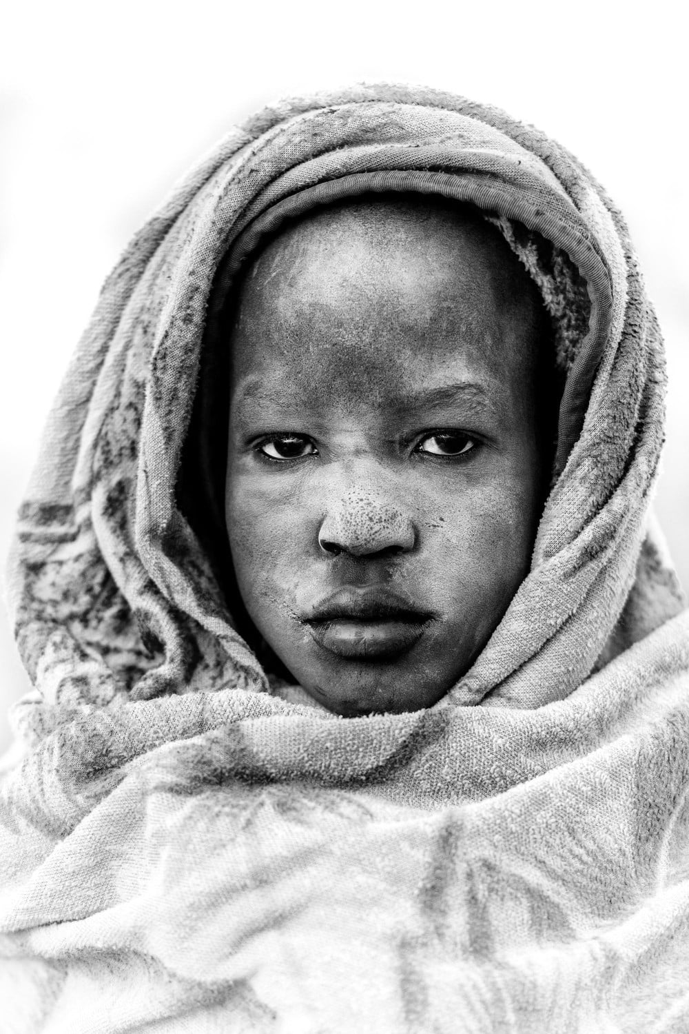 Black and white portrait of a Mundari child