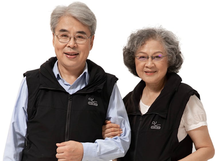 older couple wearing vests