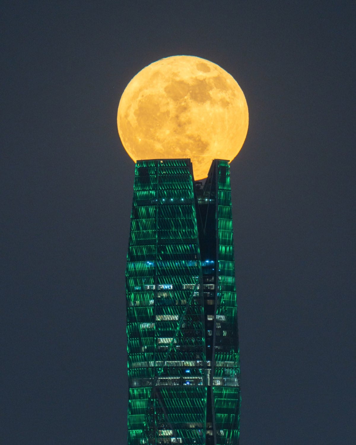 A supermoon sits at the top of the Saudi Public Investment Fund tower in Riyadh, Saudi Arabia.