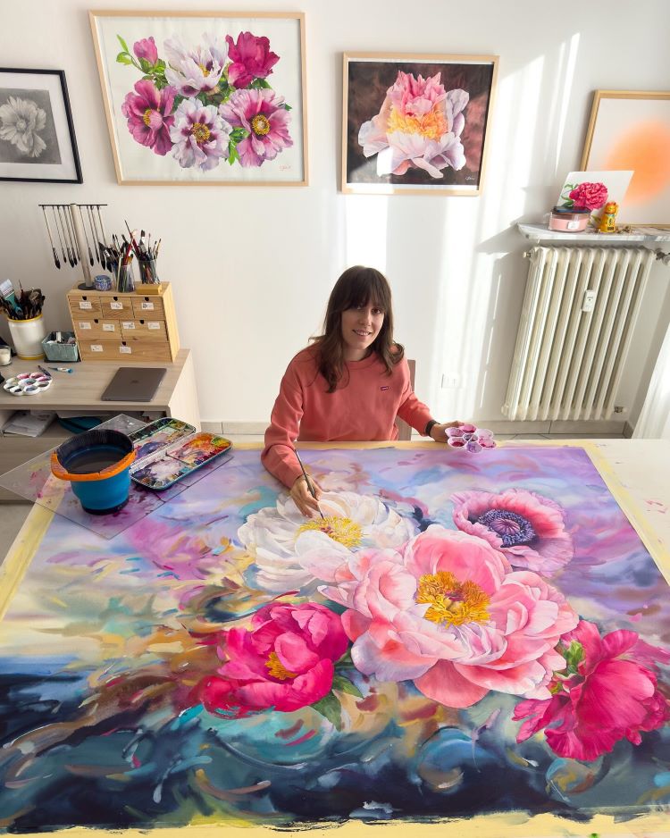 Janet Pulcho Smiling While Painting Multicolored Flowers