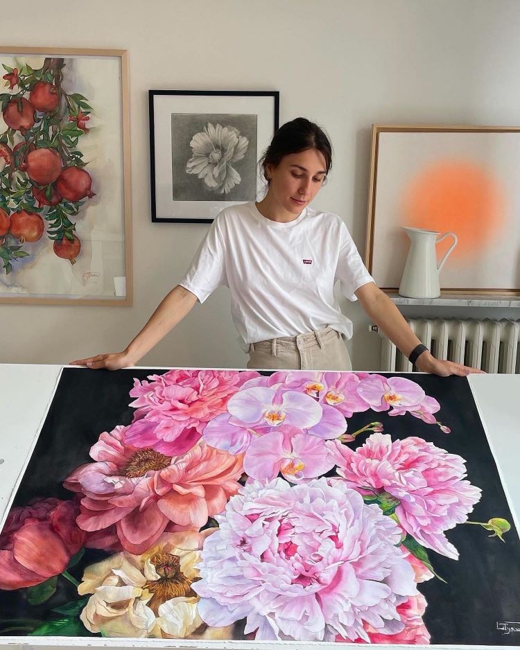 Janet Pulcho Standing Above Painting with Pink Flowers