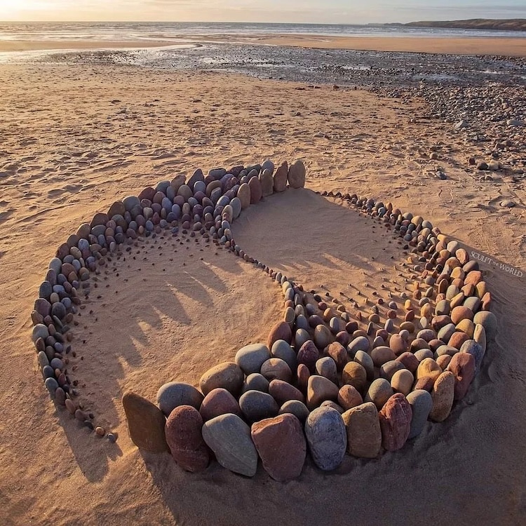 Colorful stones art on a beach by Jon Foreman