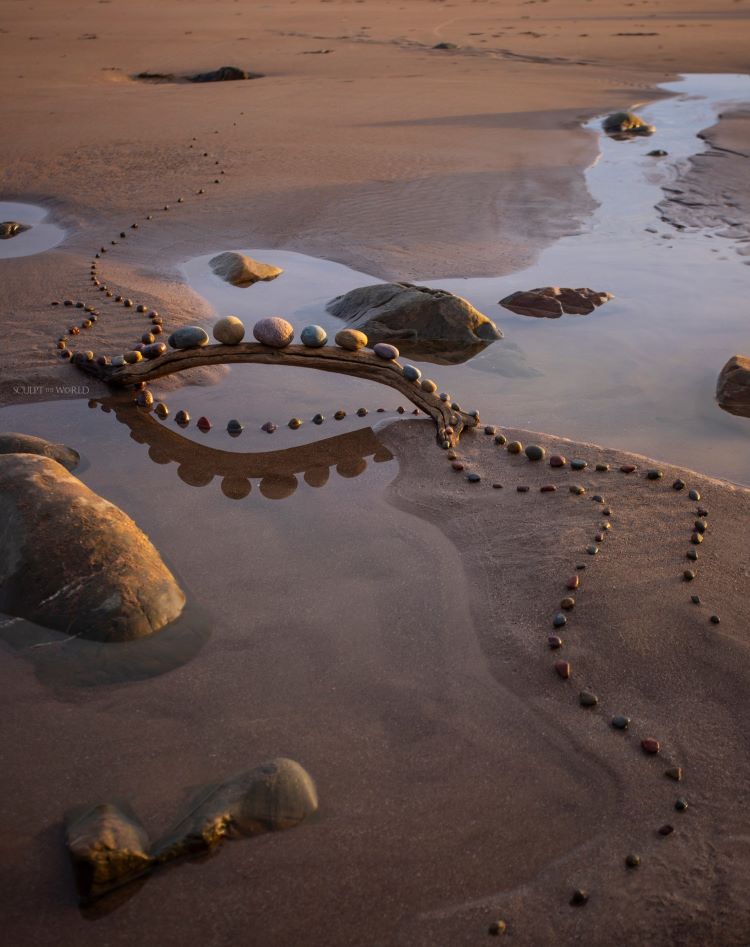 Arrangement Of Stones And Driftwood On Beach