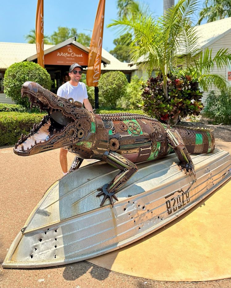 Jordan Sprigg Stands Next To His Metal Crocodile Sculpture