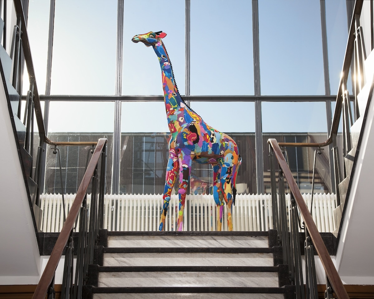 Life-size giraffe sculpture made of colorful flip-flops