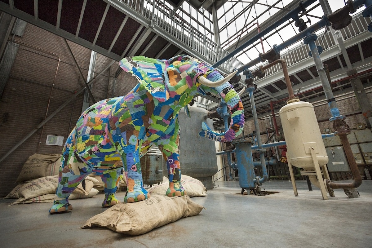 Life-size elephant sculpture made of colorful flip-flops