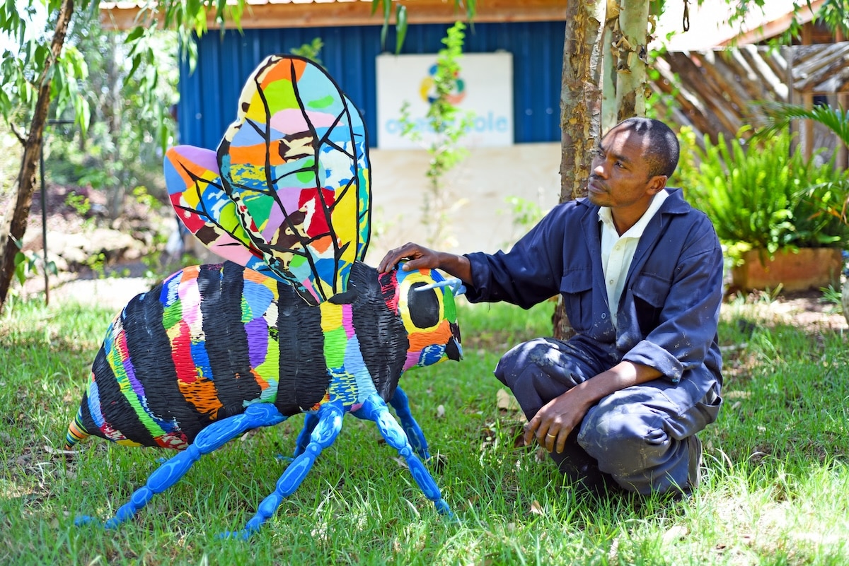 Larger-than-life bug sculpture made of colorful flip-flops