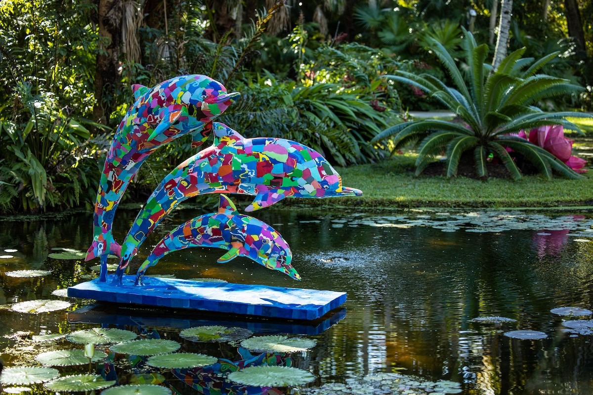 Life-size dolphin sculptures all made of colorful flip-flops