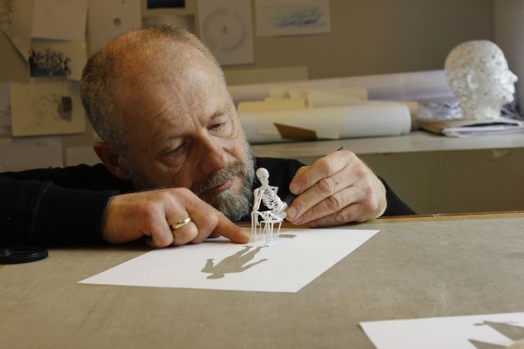 Peter Callesen With A Miniature Skeleton Made Of Paper