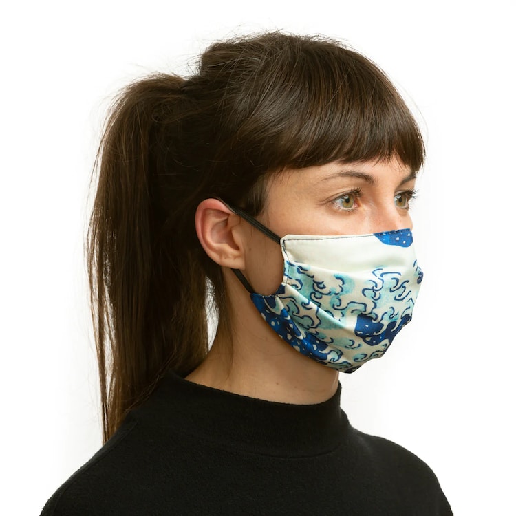 Woman wearing a Hokusai Great Wave face mask reverse side