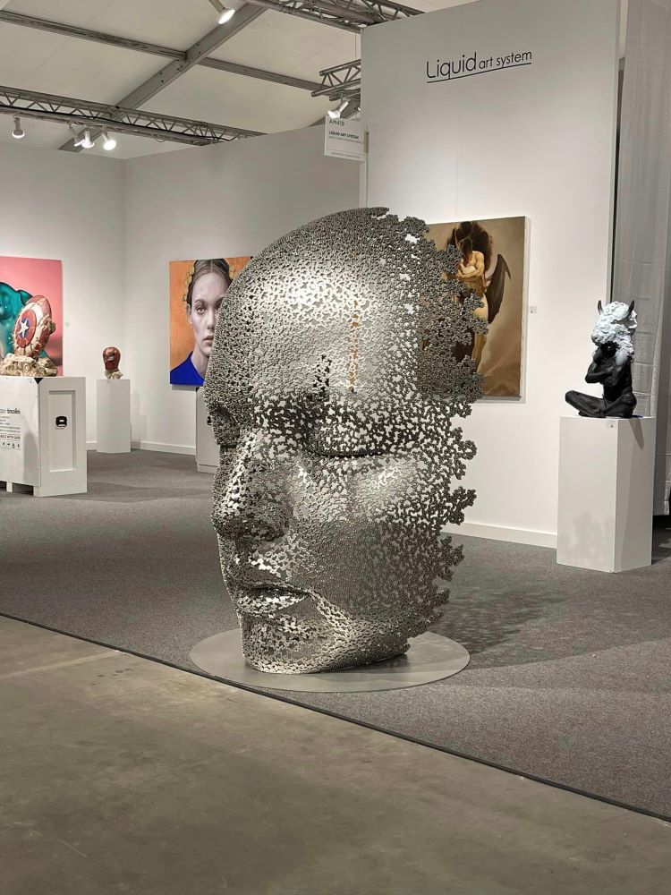 A Sculpture Of A Resting Face Made Of Bicycle Chains