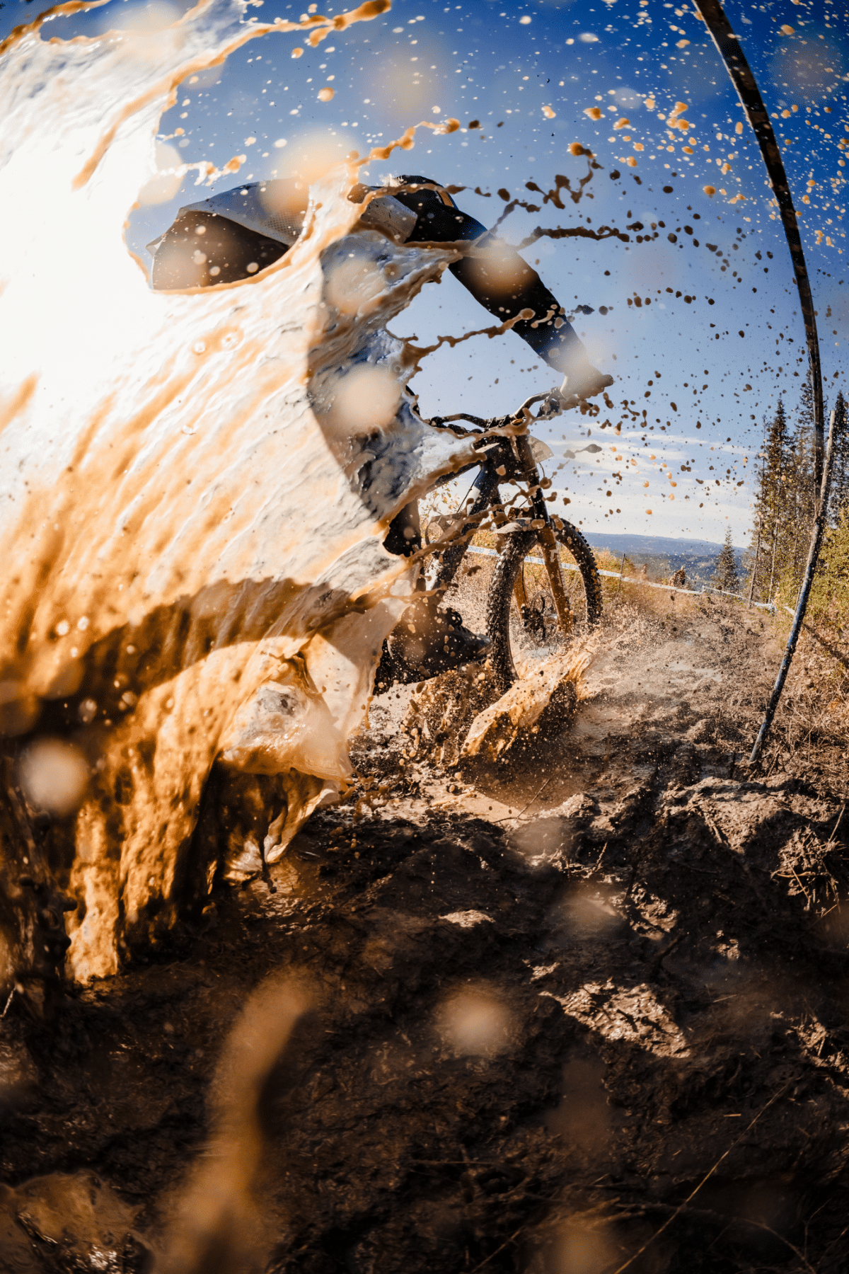 A rider passes through a muddy part of the course at the Norwegian National Championships in Hafjell Bike Park