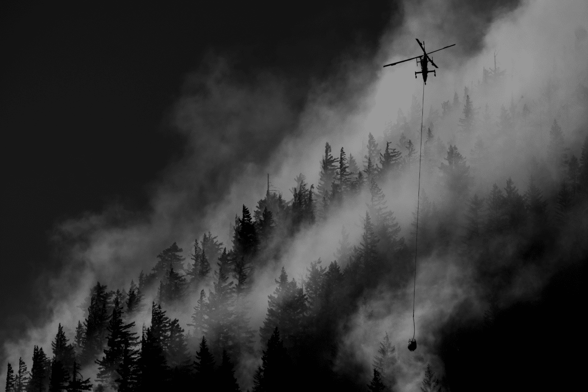 Helicopter carrying water over the Sourdough Fire in the North Cascades National Park