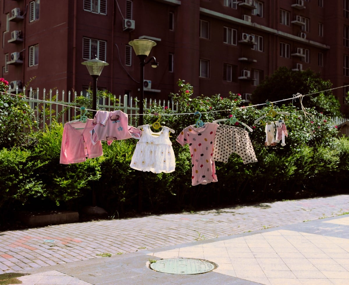 Children's clothes hanging on a clothesline in the sunshine