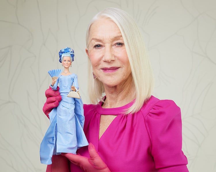 Helen Mirren holding her Barbie doll