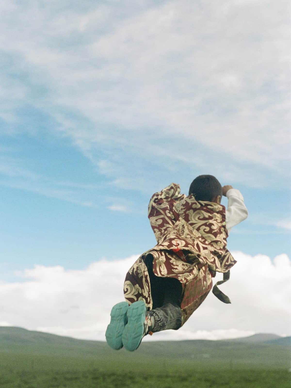 Tibetan girl jumping in the air