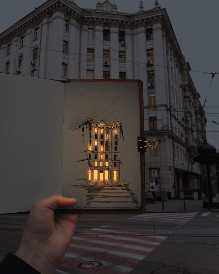 Artist Holding Glowing Pen Drawing Of Building In Front Of Real Building