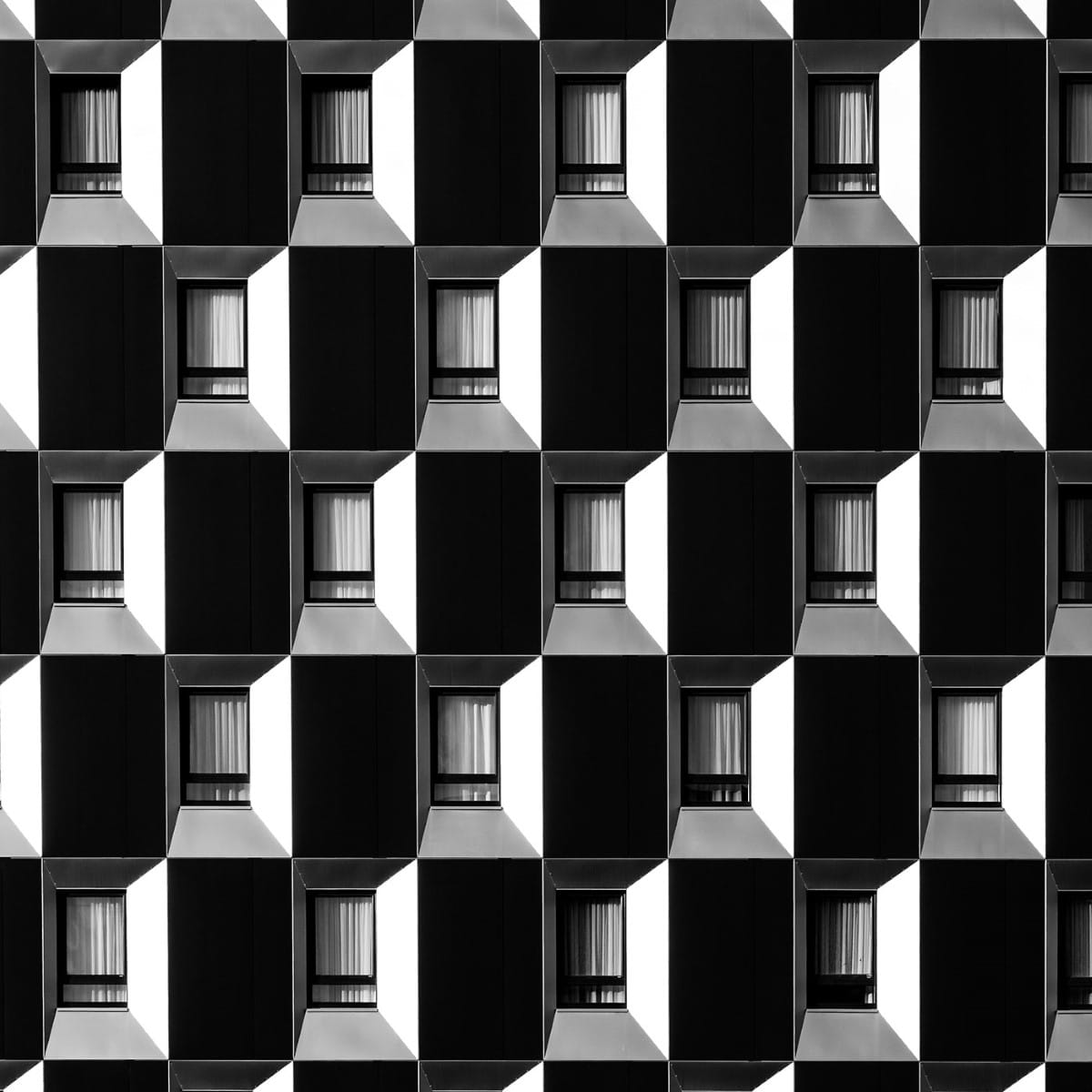 Black and white photo of windows on a skyscraper