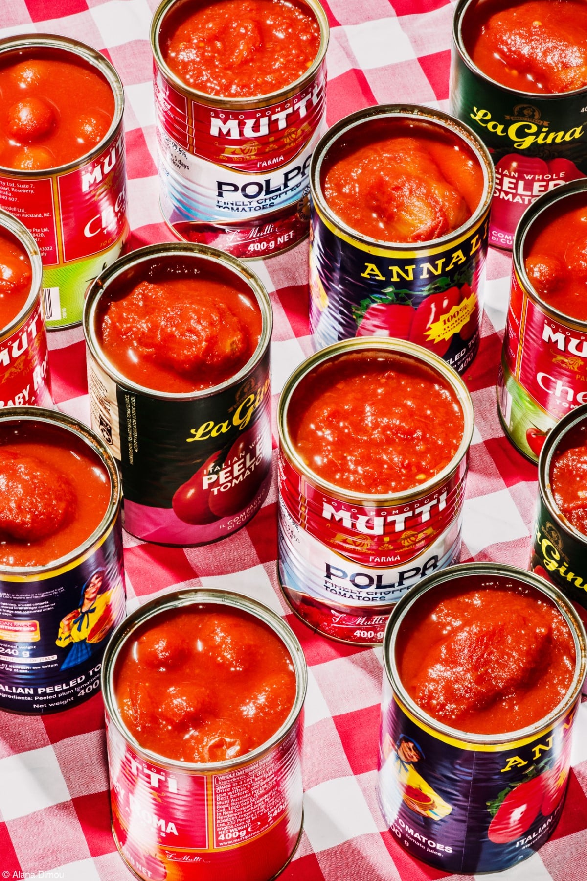 Open cans of tomatos on a table