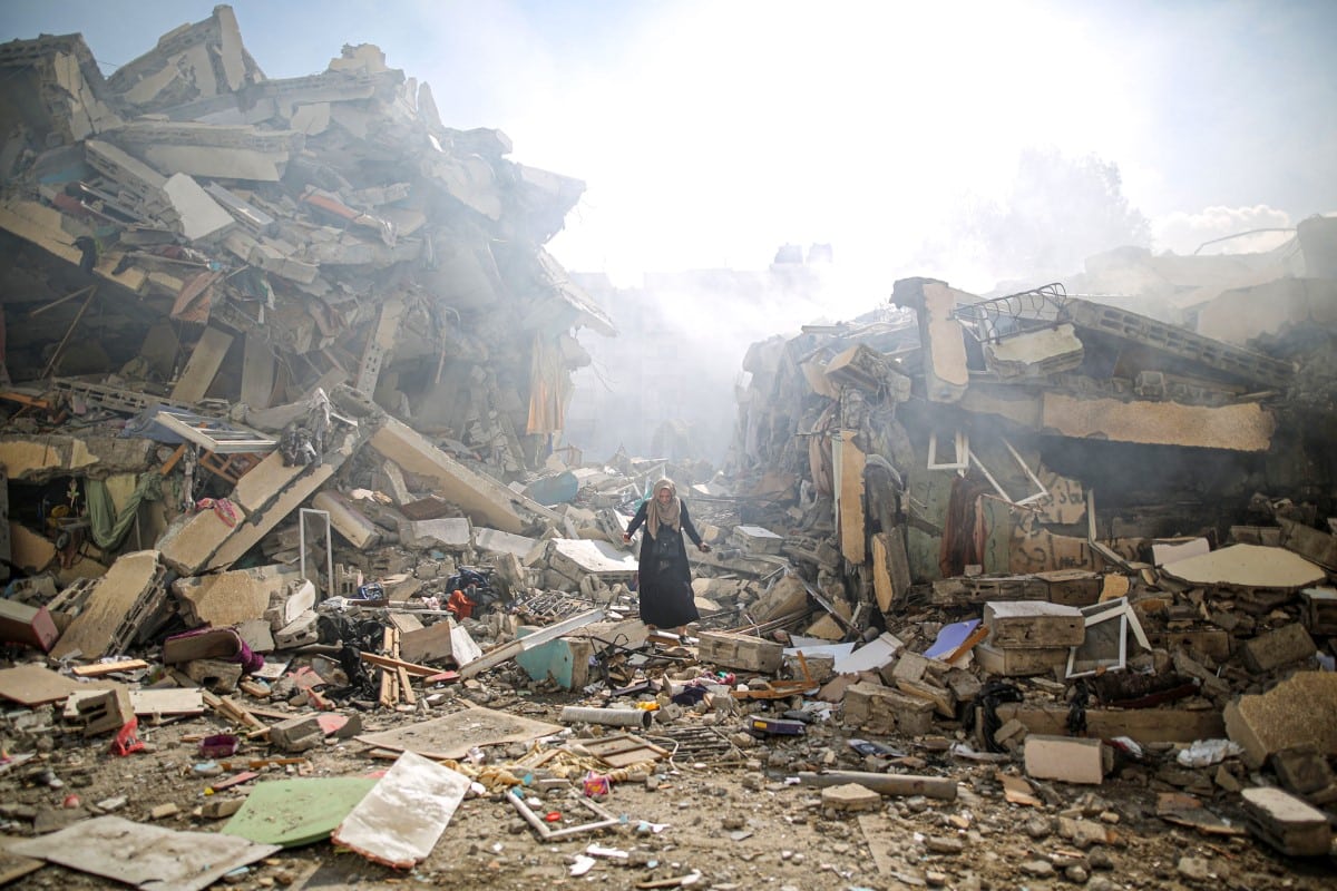 A resident of al-Zahra walks through the rubble of homes destroyed in Israeli airstrikes.