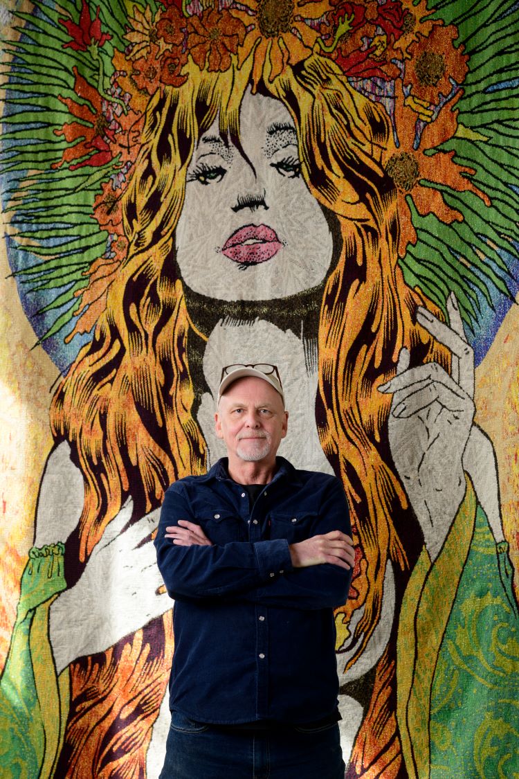 Chuck Sperry Stands In Front Of Full Scale Print Of Woman
