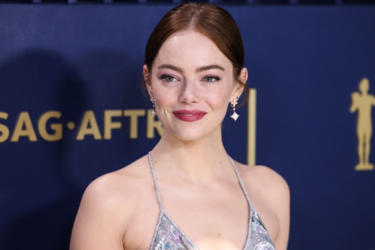 Emma Stone wearing a Louis Vuitton metallic lace slip gown, embroidered with sequins, pearls and crystals fern leaf pattern and ivory sandals with Louis Vuitton High Jewelry arrives at the 30th Annual Screen Actors Guild Awards held at the Shrine Auditorium and Expo Hall on February 24, 2024 in Los Angeles, California, United States.