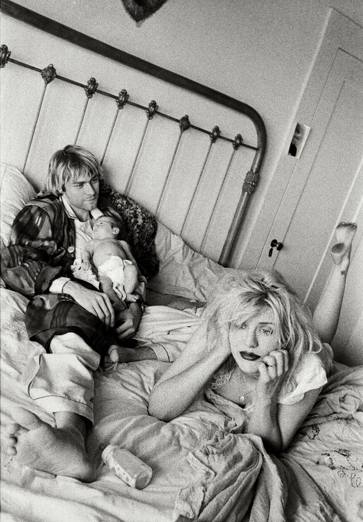 Black and White image of Kurt Cobain holding daughter Frances Bean next to Courtney Love