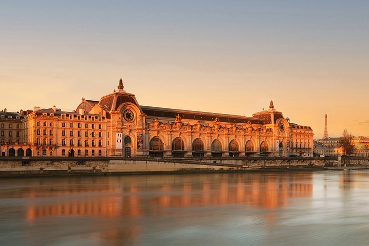 An exterior shot of the Musee D'Orsay, which will be bookable via Airbnb, overlooking the Seine.