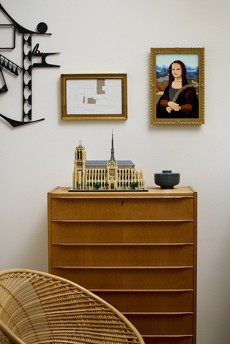 The Lego Mona Lisa is shown displayed on a wall above the LEGO Notre Dame model.