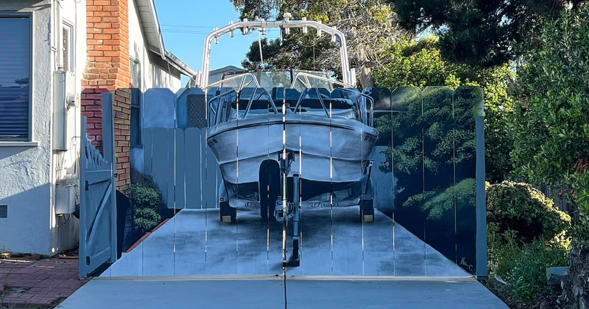 Man Trolls Officials Who Told Him to Hide His Boat by Having a Realistic Mural Painted on His New Fence