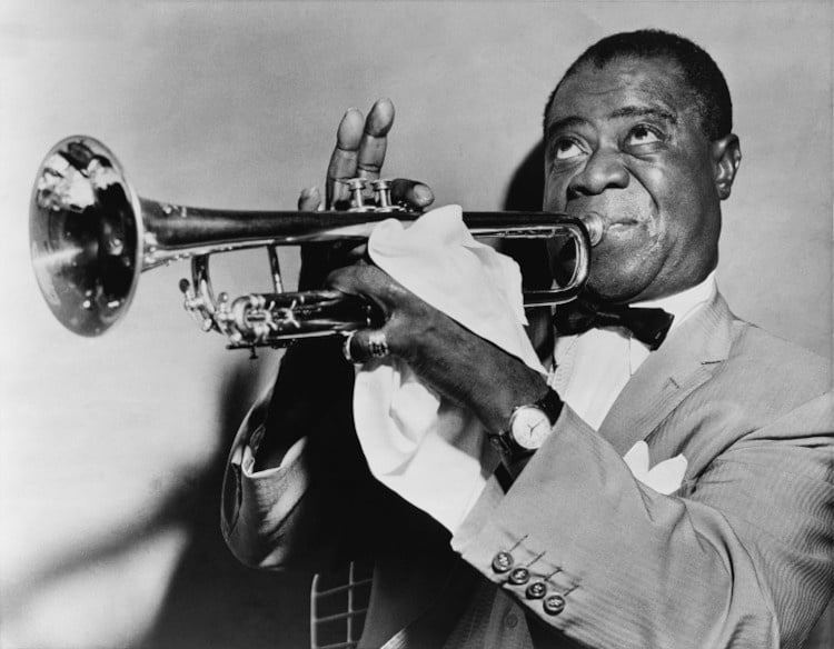 Louis Armstrong holding his trumpet