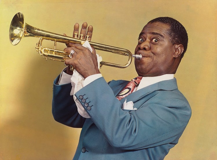 Louis Armstrong holding his trumpet