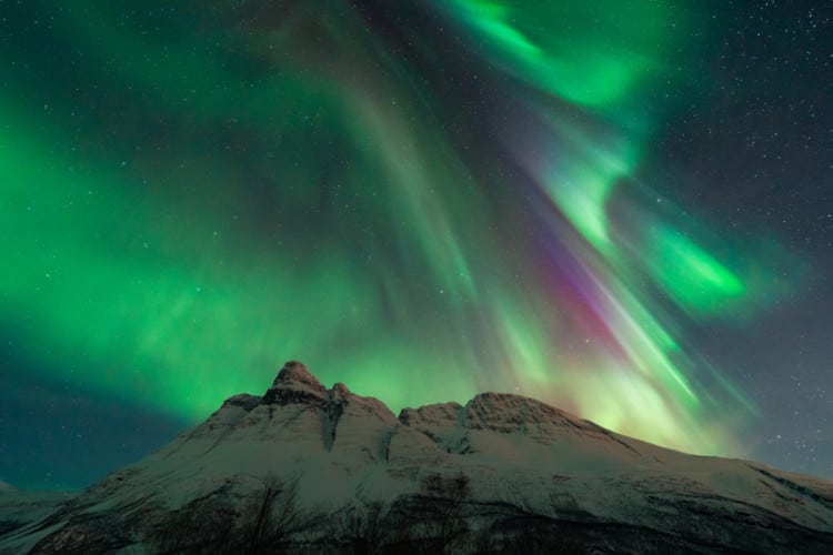 Northern Lights over snowy mountain