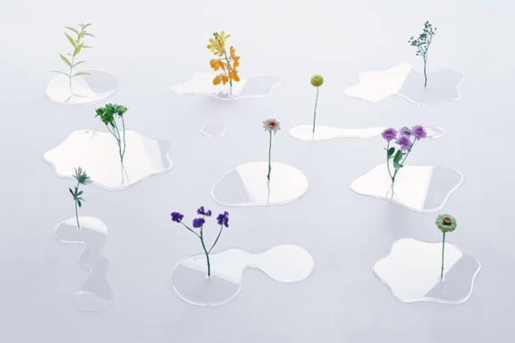 Flowers in clear puddle-like vases