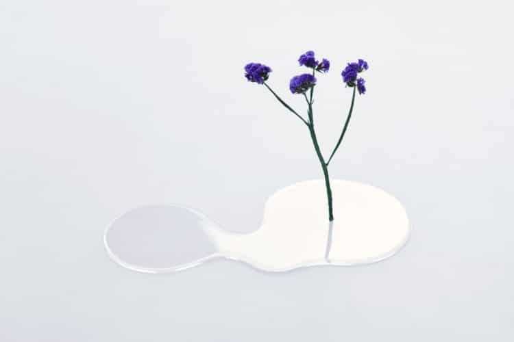 Flower in a clear puddle-like vase