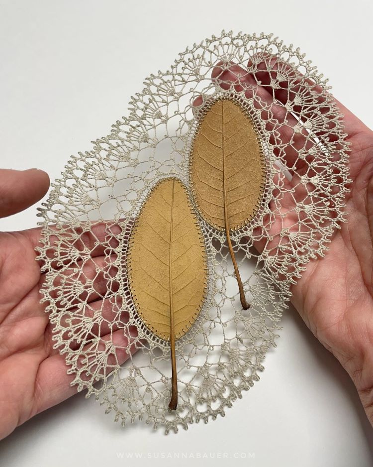 Hands Holding Two Leaves With Crocheted Lace Around Them By Susanna Bauer